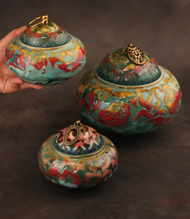 Ceramic lidded jars styled on a refined console table with warm lighting