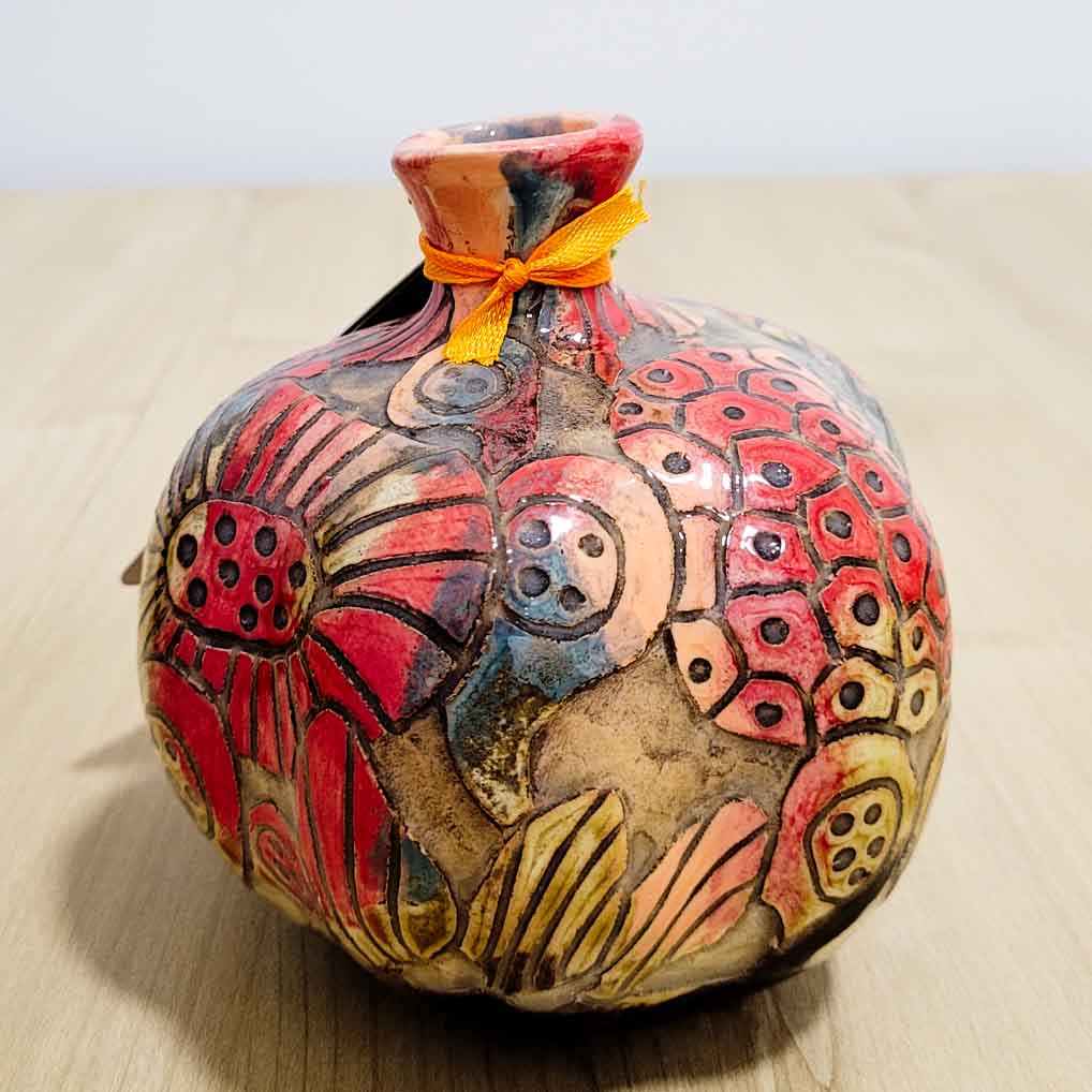 Ceramic pomegranate décor styled as a dining table centrepiece