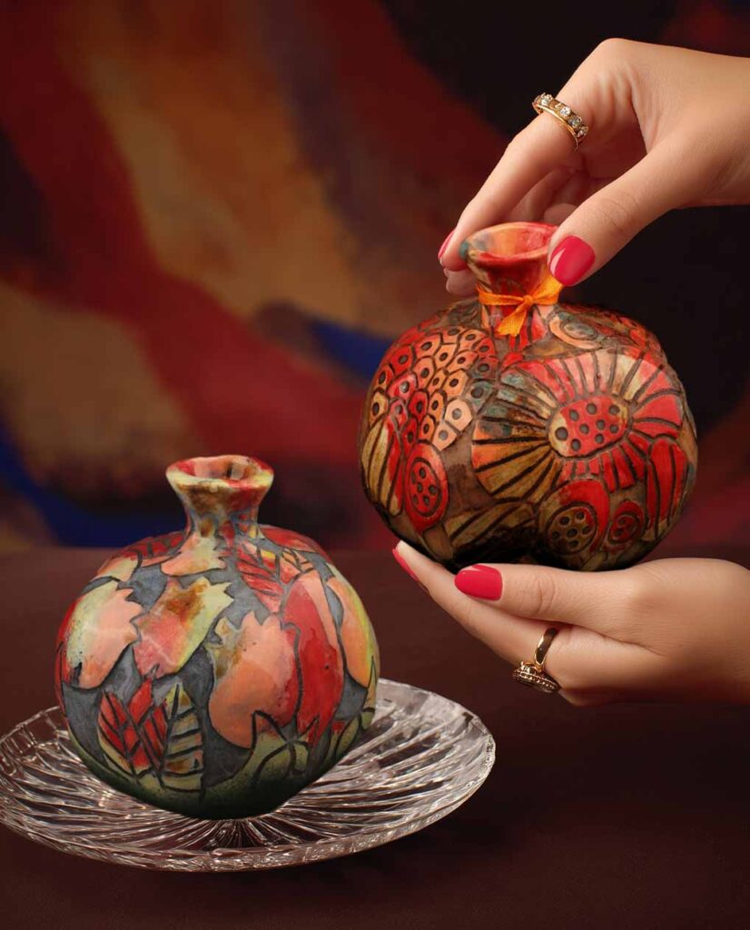 Close-up of ceramic pomegranate décor showing symbolic form and handcrafted detail