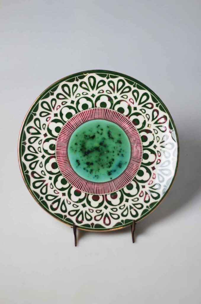 Decorative ceramic dish displayed as handmade ceramic wall art in a refined interior