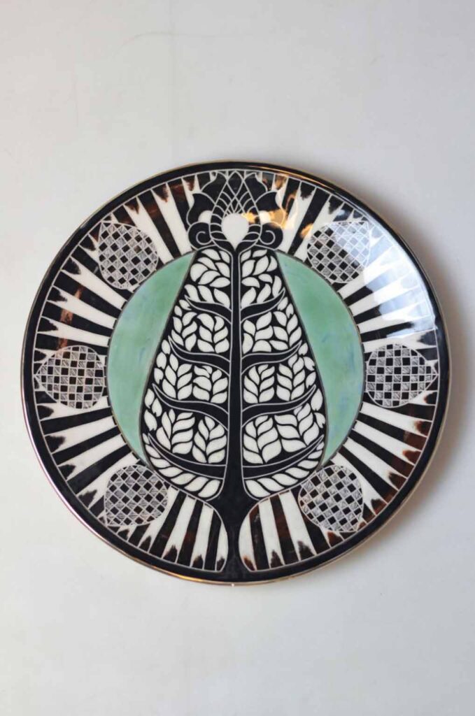 Decorative ceramic dishes arranged as ceramic wall art in a refined interior