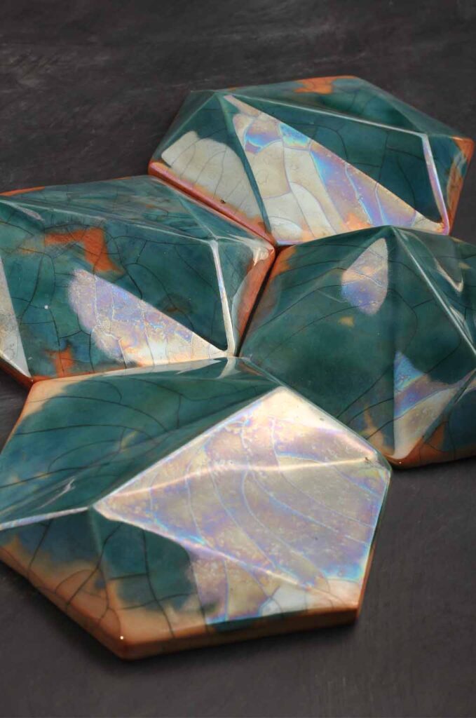 Close-up of glazed ceramic wall tile showing handmade texture and surface detail emerald