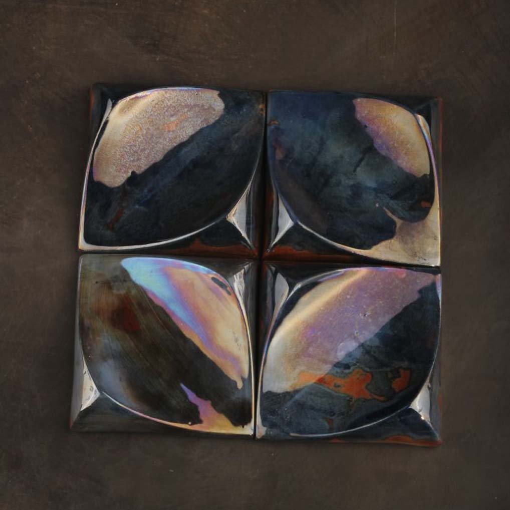 Glazed ceramic wall tiles used as handcrafted ceramic wall art in an elegant interior