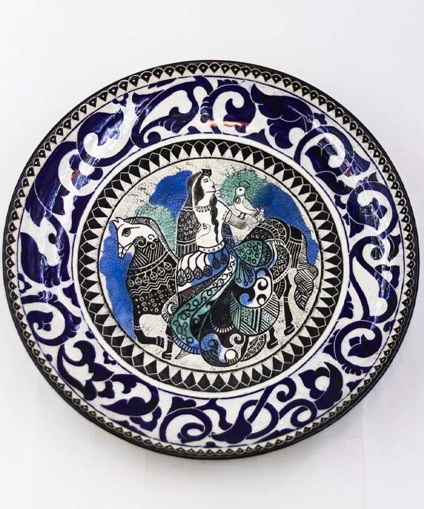 Hand-painted ceramic decor styled dish in a refined interior with warm lighting