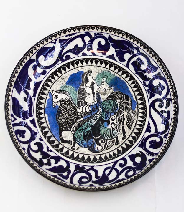 Hand-painted ceramic decor styled dish in a refined interior with warm lighting