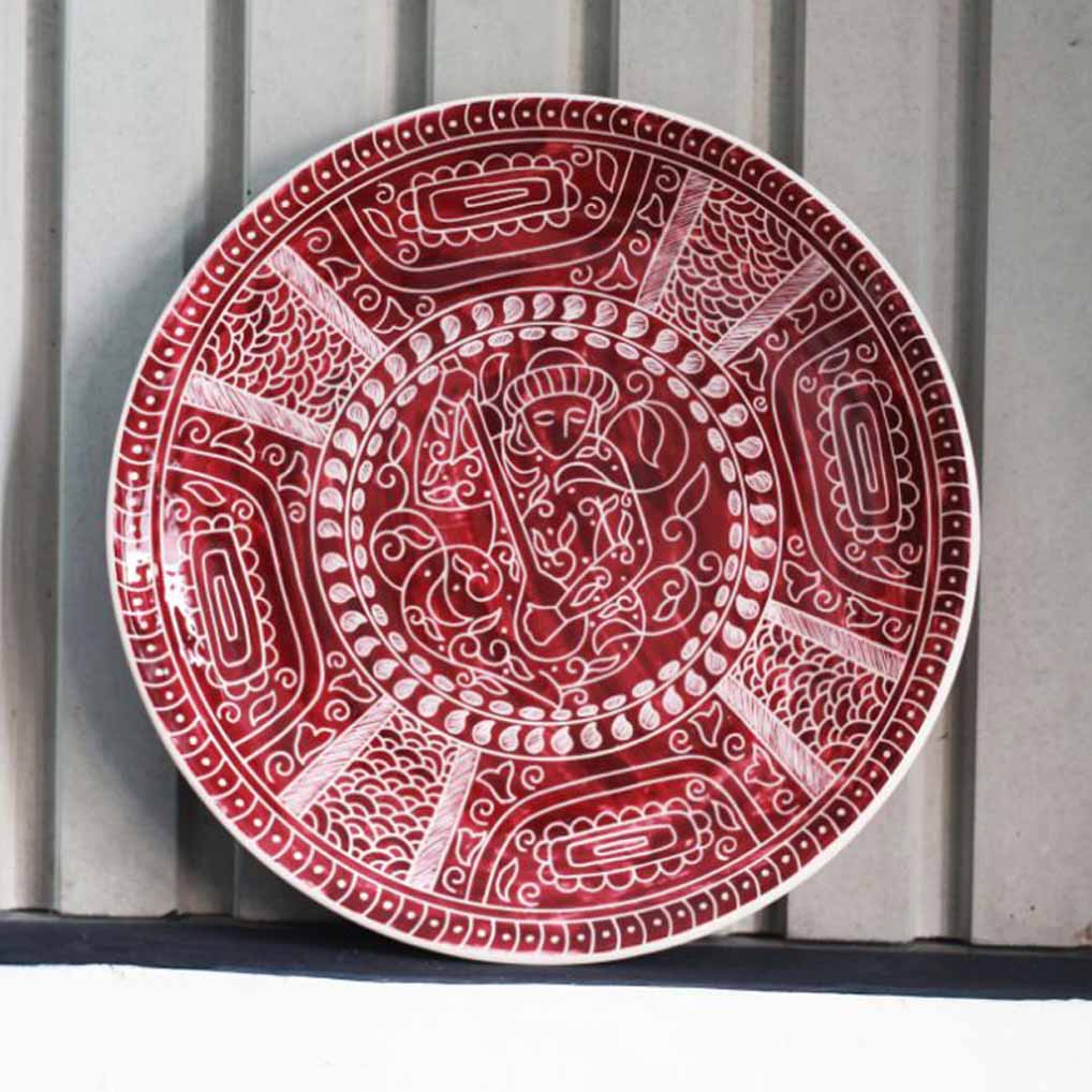 : Close-up of hand-painted decorative ceramic dish with glazed surface detail