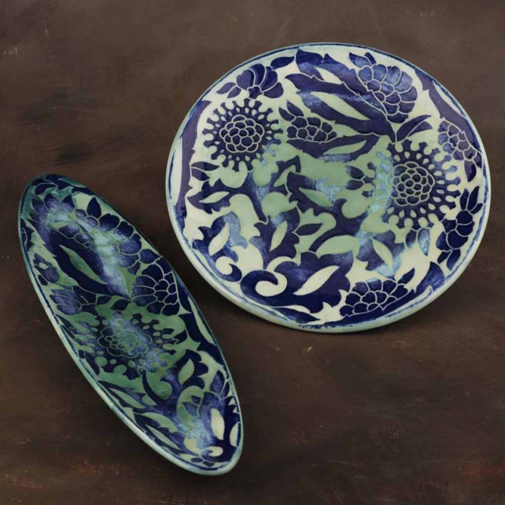 Hand-painted ceramic decor styled with wood, stone, brass and oval and circle dishes