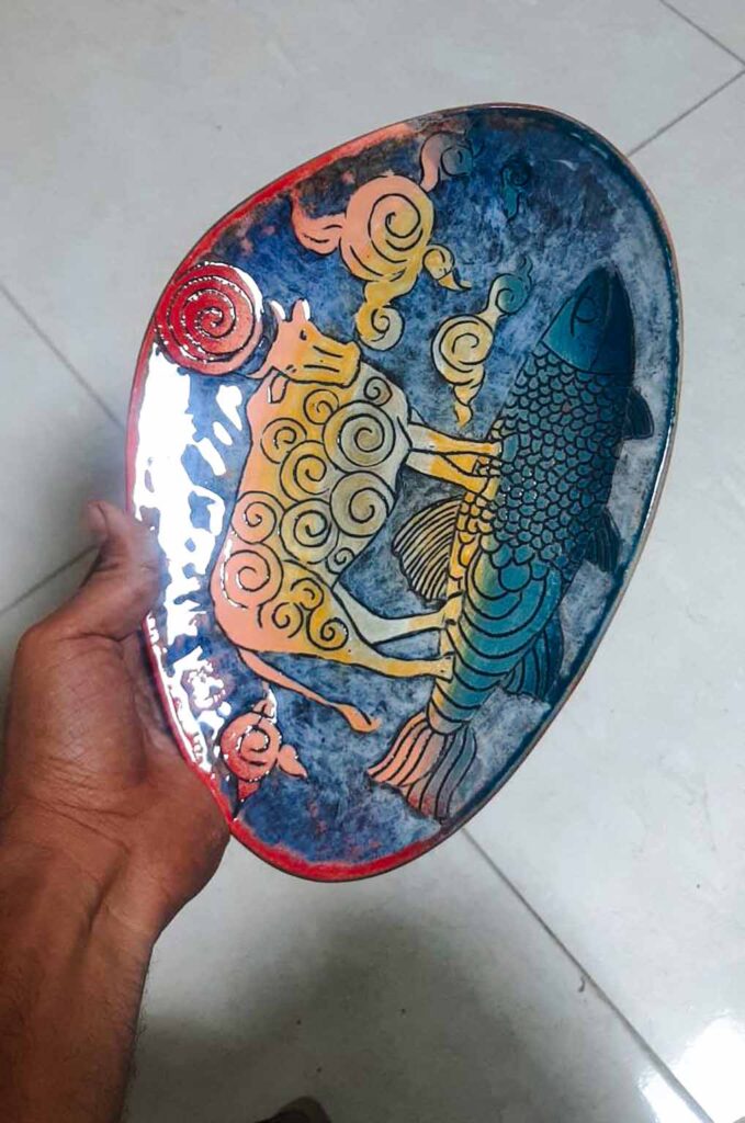 Handmade ceramic decor styled on a oval dish in a refined interior